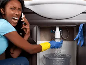 Emergency plumbing repair for a leaking sink drain under a bathroom vanity in New Orleans, LA