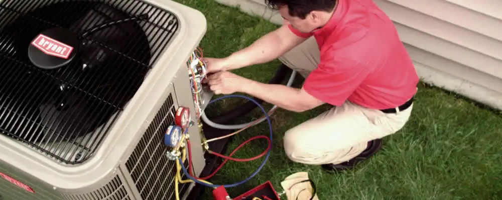 HVAC technician servicing an outdoor air conditioner unit in New Orleans, LA